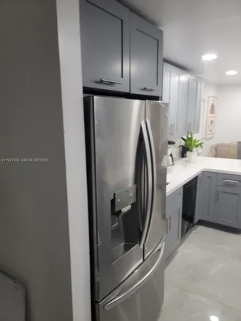 a kitchen with a refrigerator and a sink