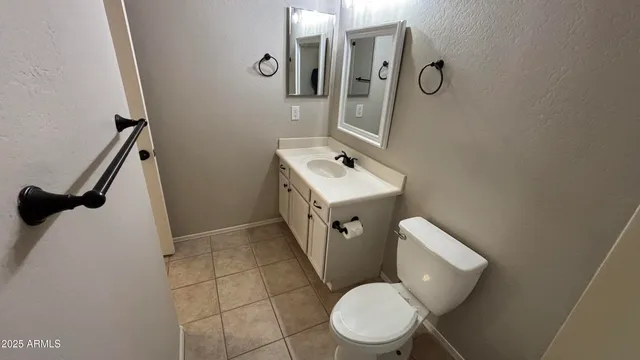 a white toilet sitting next to a bathroom sink