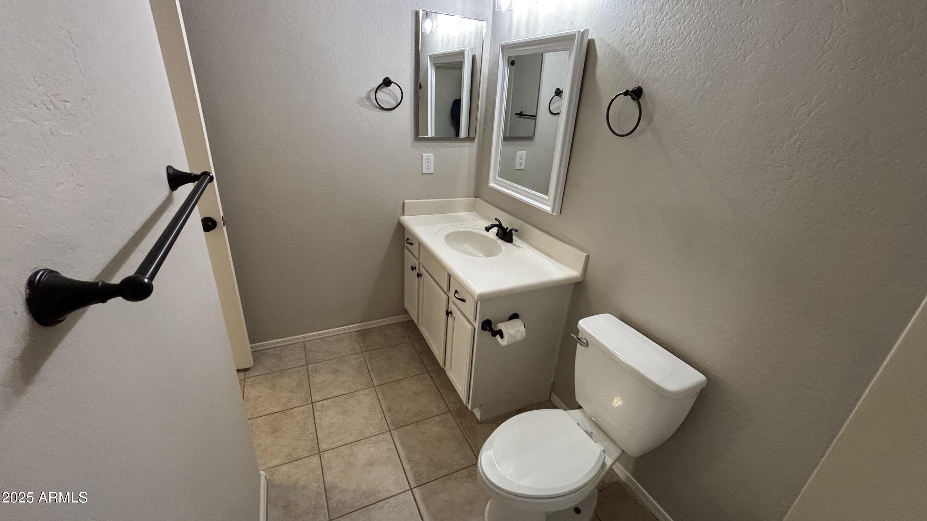 2587 West Patagonia Way Phoenix, AZ 85086 - Photo 13 of 19 a white toilet sitting next to a bathroom sink