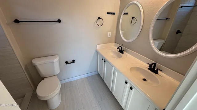 a bathroom with a sink mirror and toilet