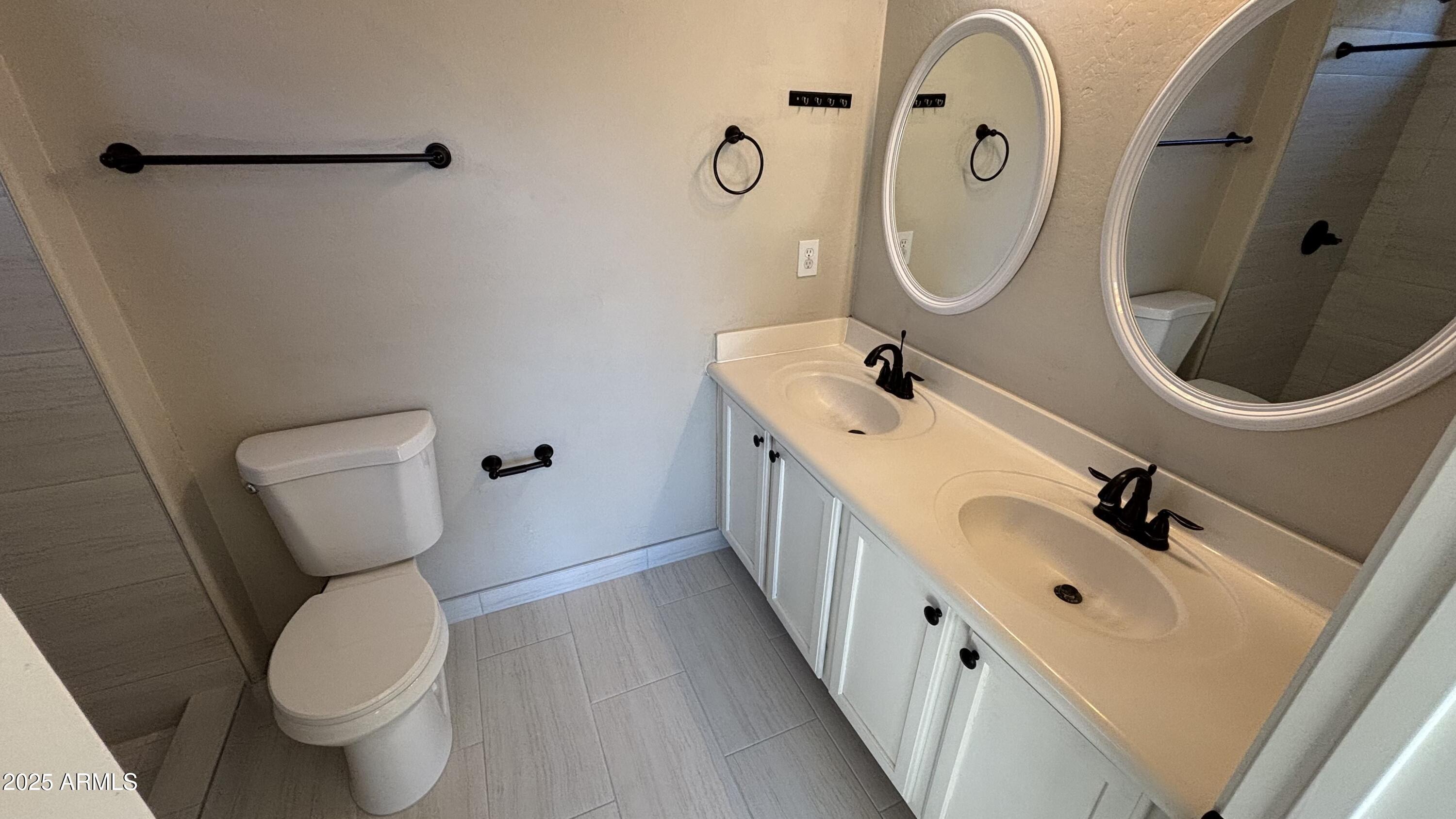 2587 West Patagonia Way Phoenix, AZ 85086 - Photo 9 of 19 a bathroom with a sink mirror and toilet