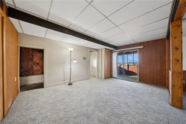 a view of a hallway with wooden shelves