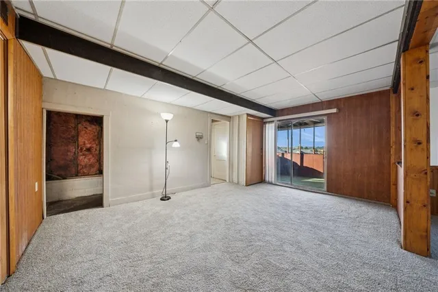 a view of a hallway with wooden shelves