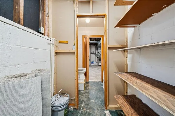 a bathroom with a toilet and a shower