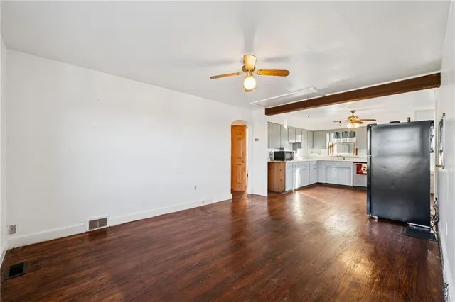 a view of a kitchen with a sink and wooden floor