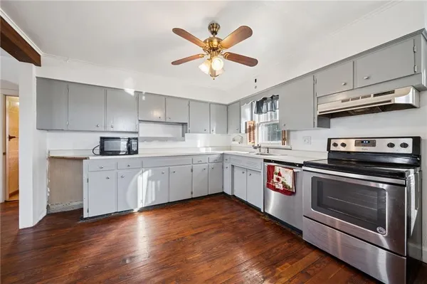 a kitchen with stainless steel appliances white cabinets and a sink