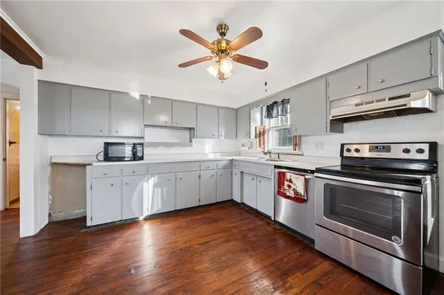 a kitchen with stainless steel appliances white cabinets and a sink