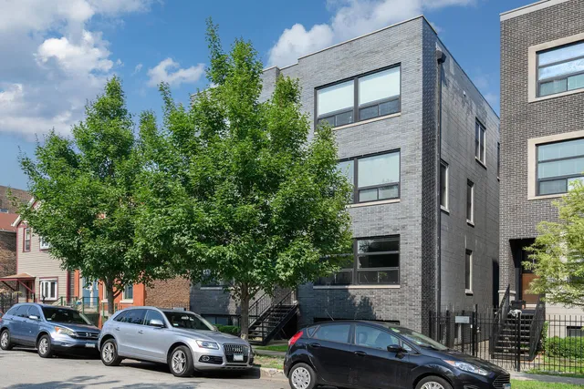 a view of a car parked in front of a brick house