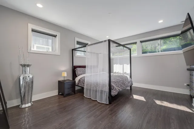 a bedroom with a bed window and a mirror