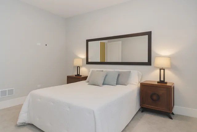 a bedroom with a bed and a lamp