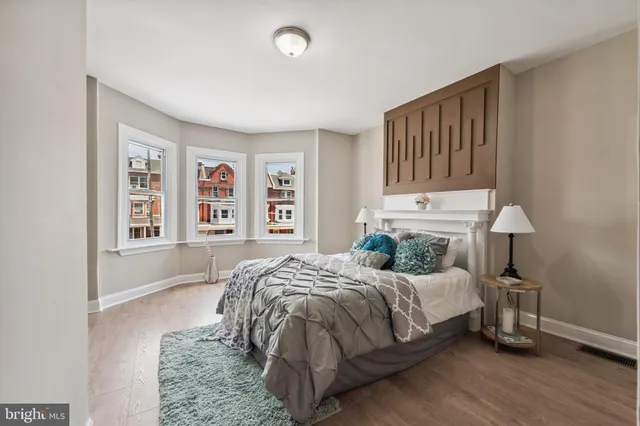 a bedroom with a bed a table and chair