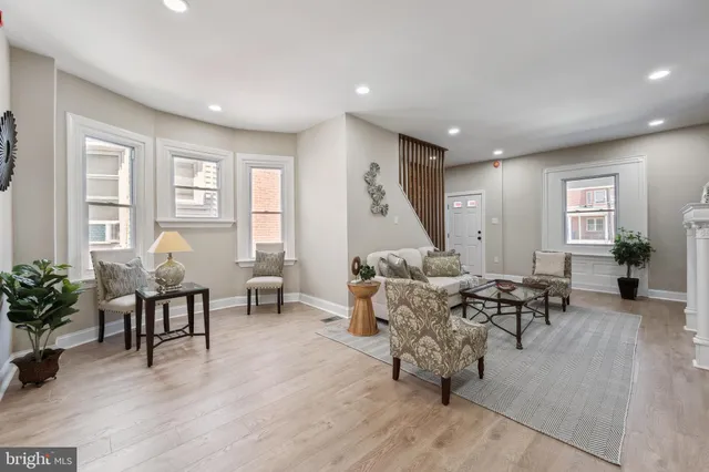a living room with furniture and wooden floor