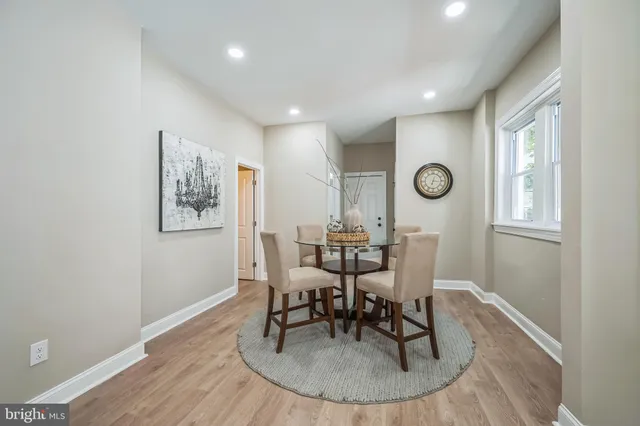 a view of a dining room with furniture and a window
