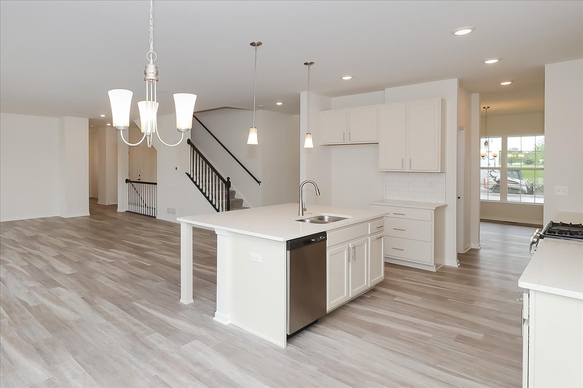 10782 Chadsey Road Huntley, IL 60142 - Photo 11 of 33 a kitchen with a stove a sink and wooden floor