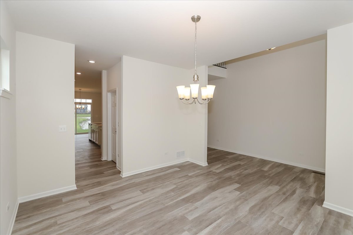 10782 Chadsey Road Huntley, IL 60142 - Photo 4 of 33 a view of empty room with wooden floor
