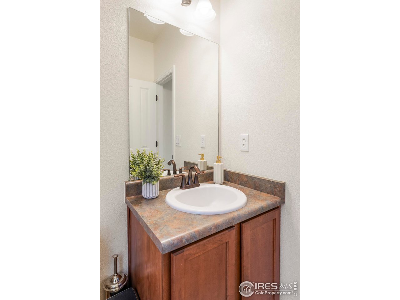 13420 Spruce Street Thornton, CO 80602 - Photo 18 of 48 a bathroom with a sink and a mirror