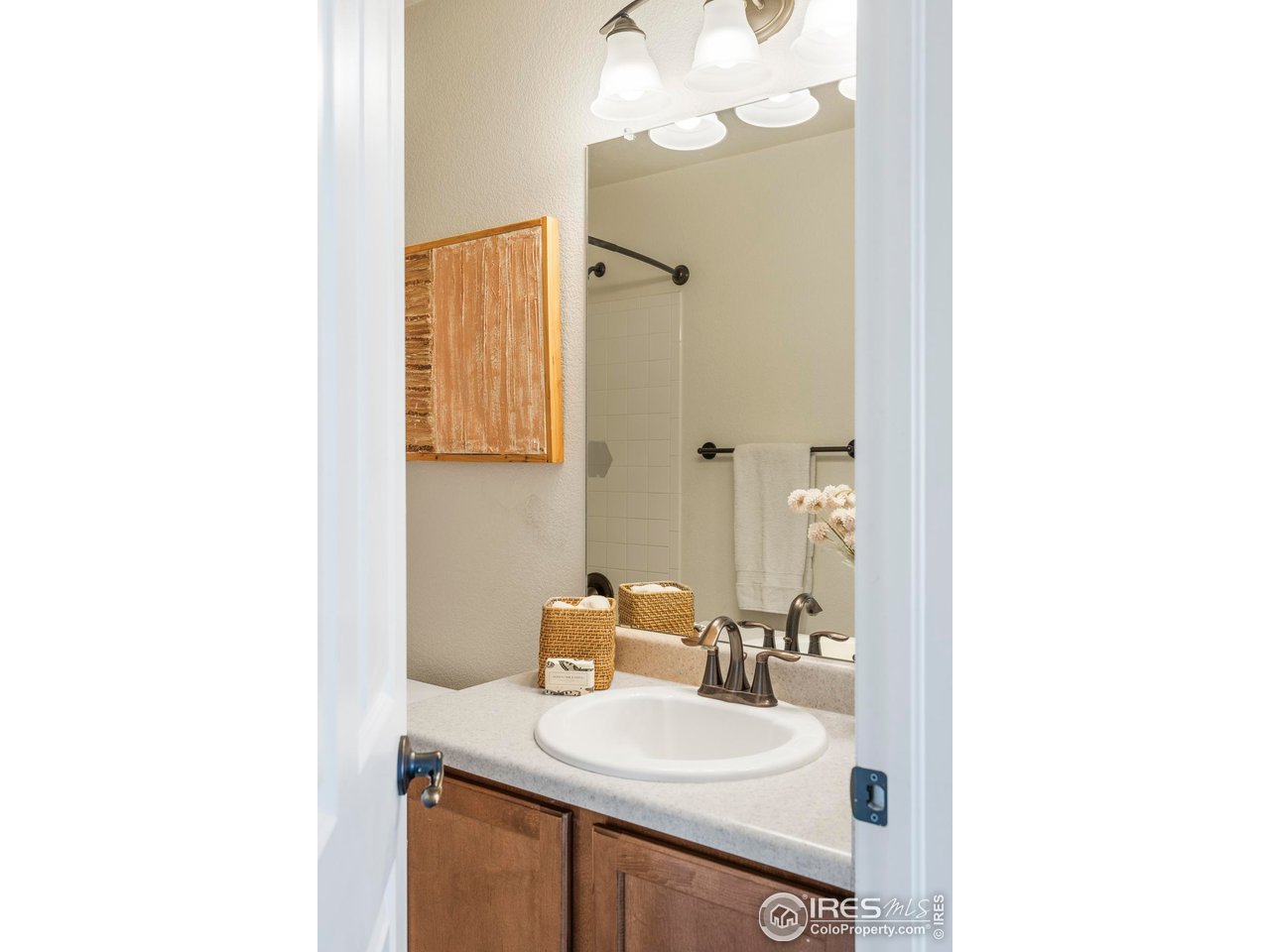 13420 Spruce Street Thornton, CO 80602 - Photo 28 of 48 a bathroom with a sink and a mirror