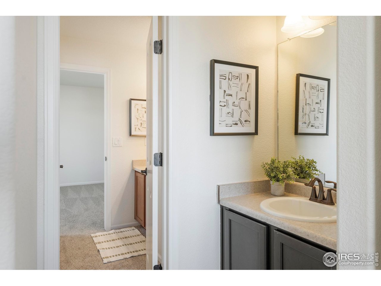 13420 Spruce Street Thornton, CO 80602 - Photo 30 of 48 a bathroom with a sink mirror and a