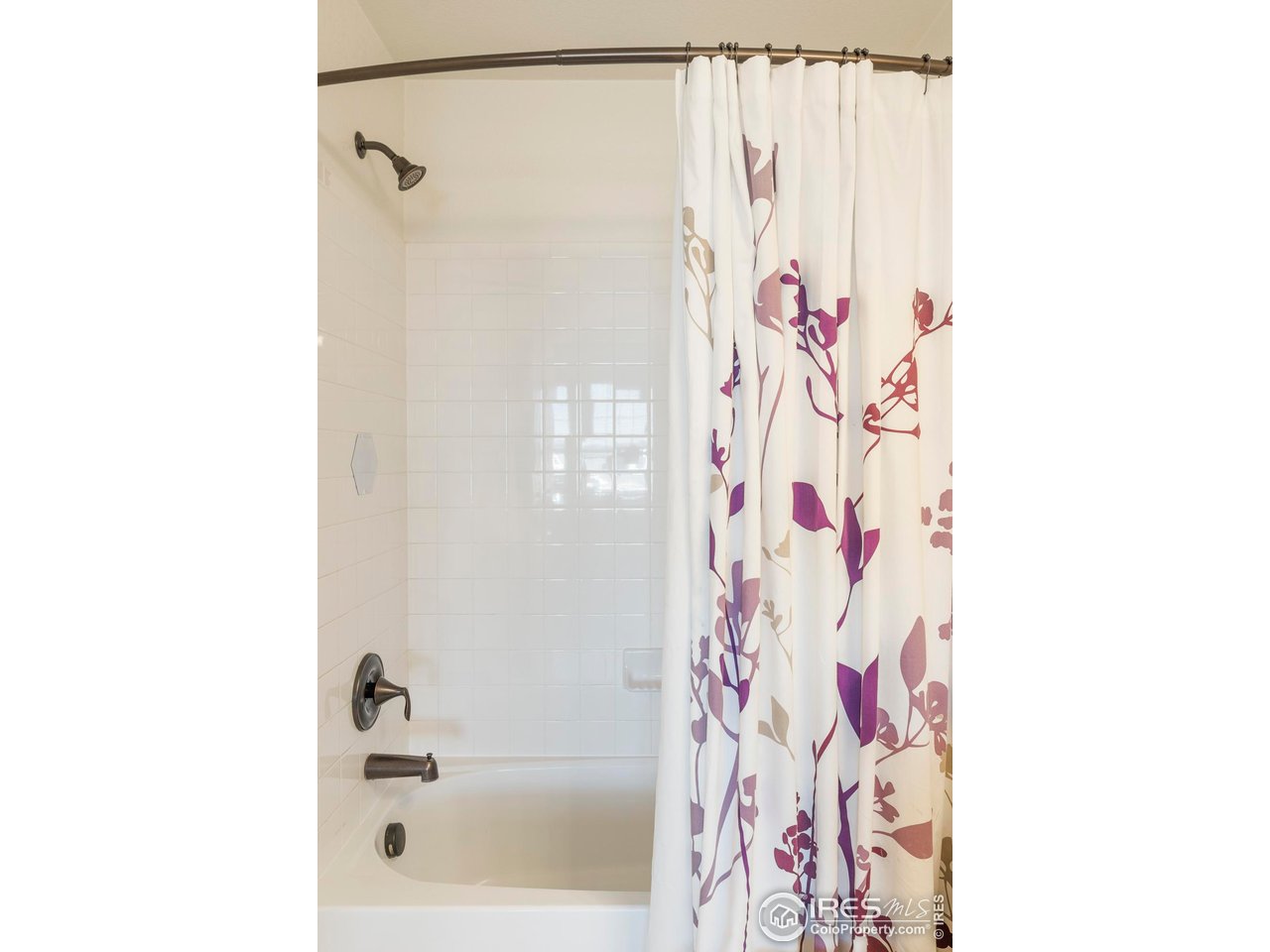 13420 Spruce Street Thornton, CO 80602 - Photo 31 of 48 a bathroom with a shower curtain and a curtain