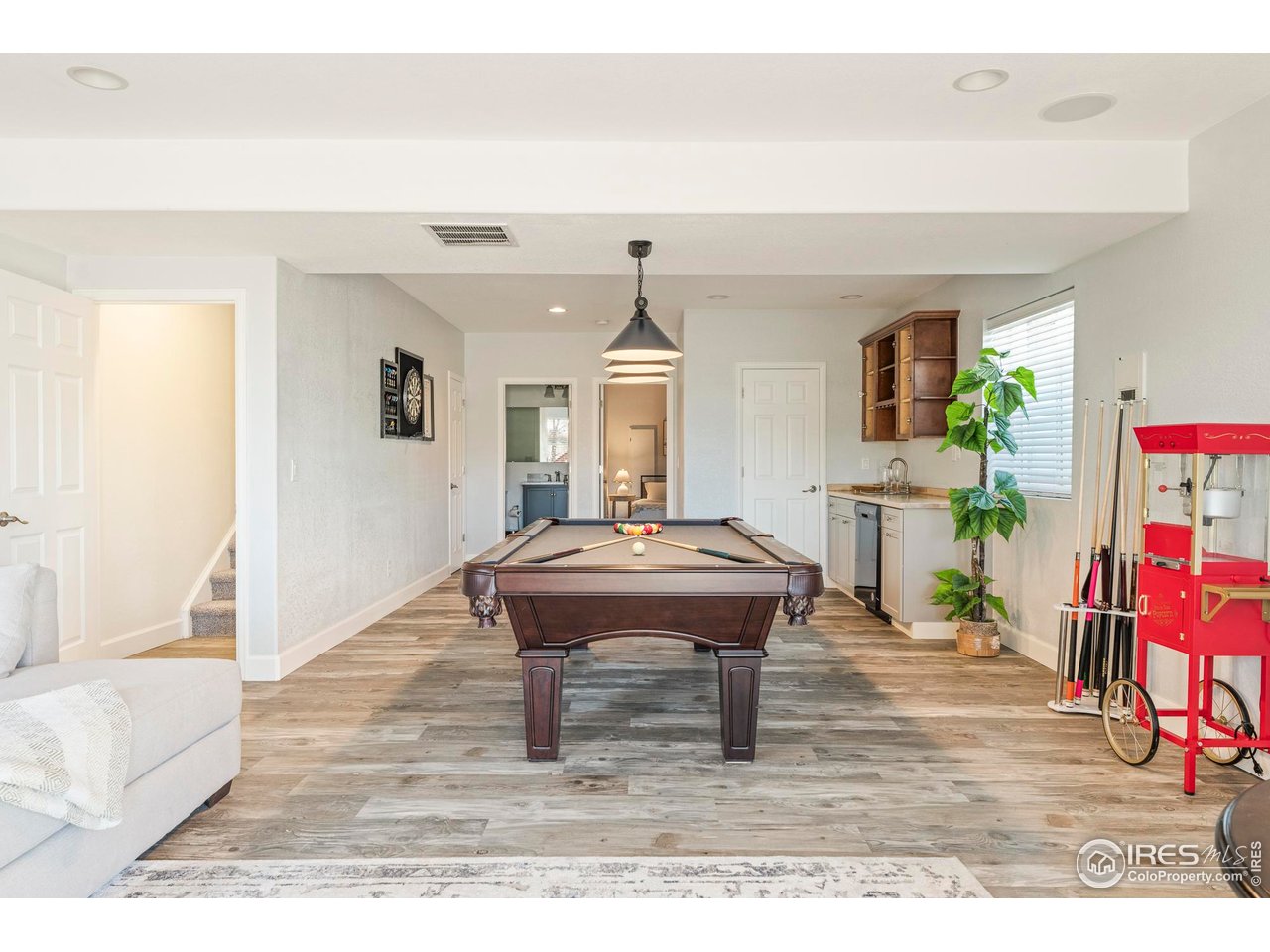 13420 Spruce Street Thornton, CO 80602 - Photo 33 of 48 a living room with a table and a wooden floor