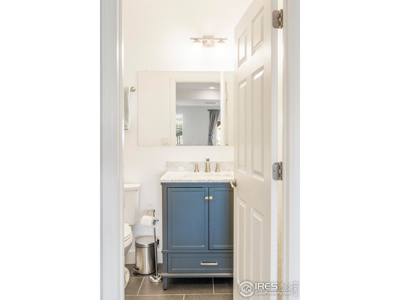 13420 Spruce Street Thornton, CO 80602 - Photo 38 of 48 a bathroom with a sink a mirror and vanity