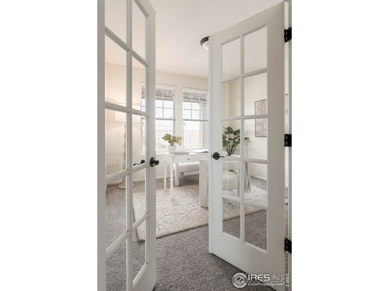 13420 Spruce Street Thornton, CO 80602 - Photo 9 of 48 a living room with furniture a large window and chairs