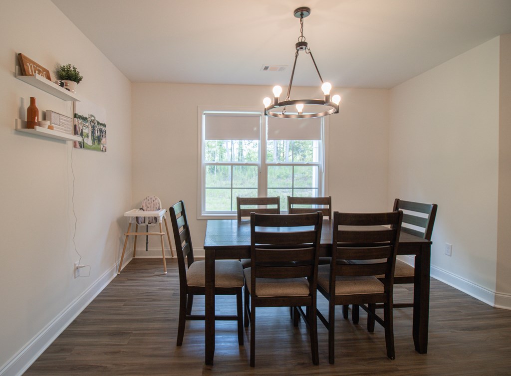 25 Veterans Court Fort Mitchell, AL 36856 - Photo 13 of 32 a view of a dining room with furniture a chandelier and wooden floor