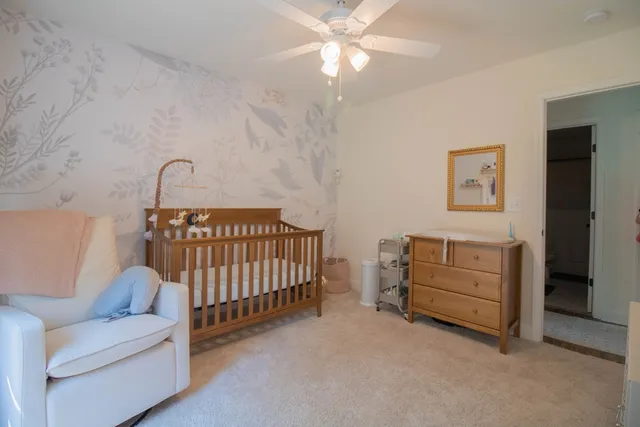 a bedroom with a baby bed baby crib and a couch