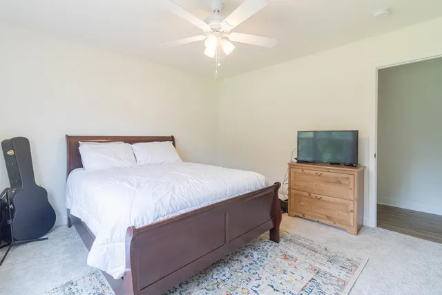 a bedroom with a bed and a dresser