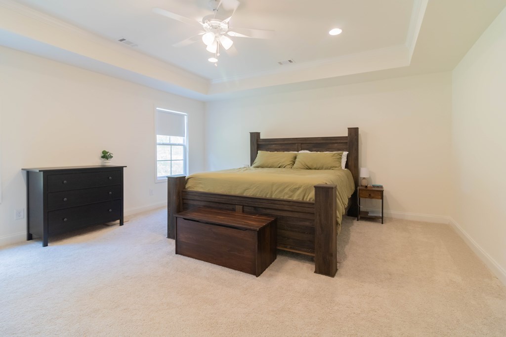 25 Veterans Court Fort Mitchell, AL 36856 - Photo 23 of 32 a bed room with a bed and a lamp