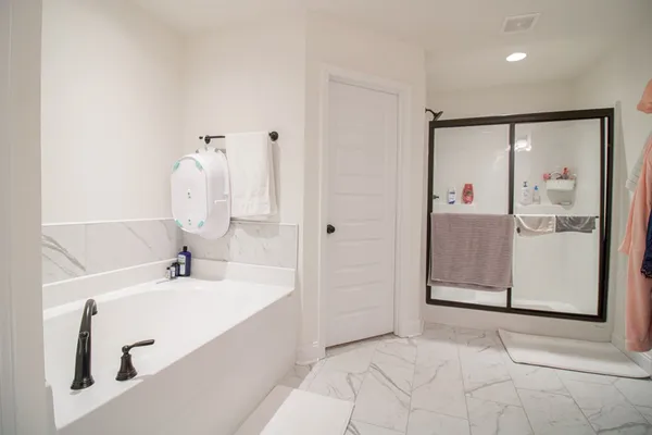 a bathroom with a bathtub sink and mirror