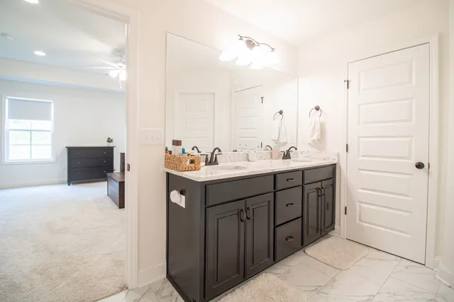 a bathroom with a sink vanity and mirror