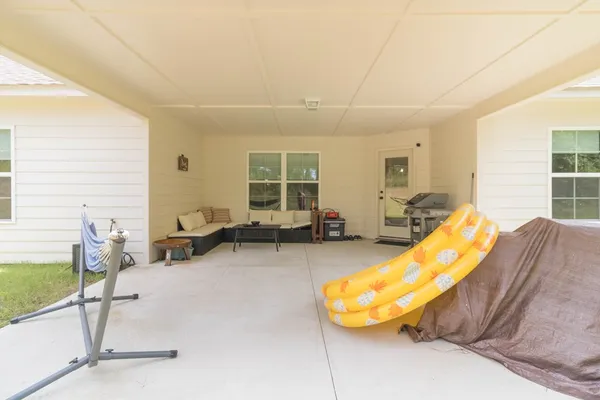 a living room with furniture gym equipment and a large window