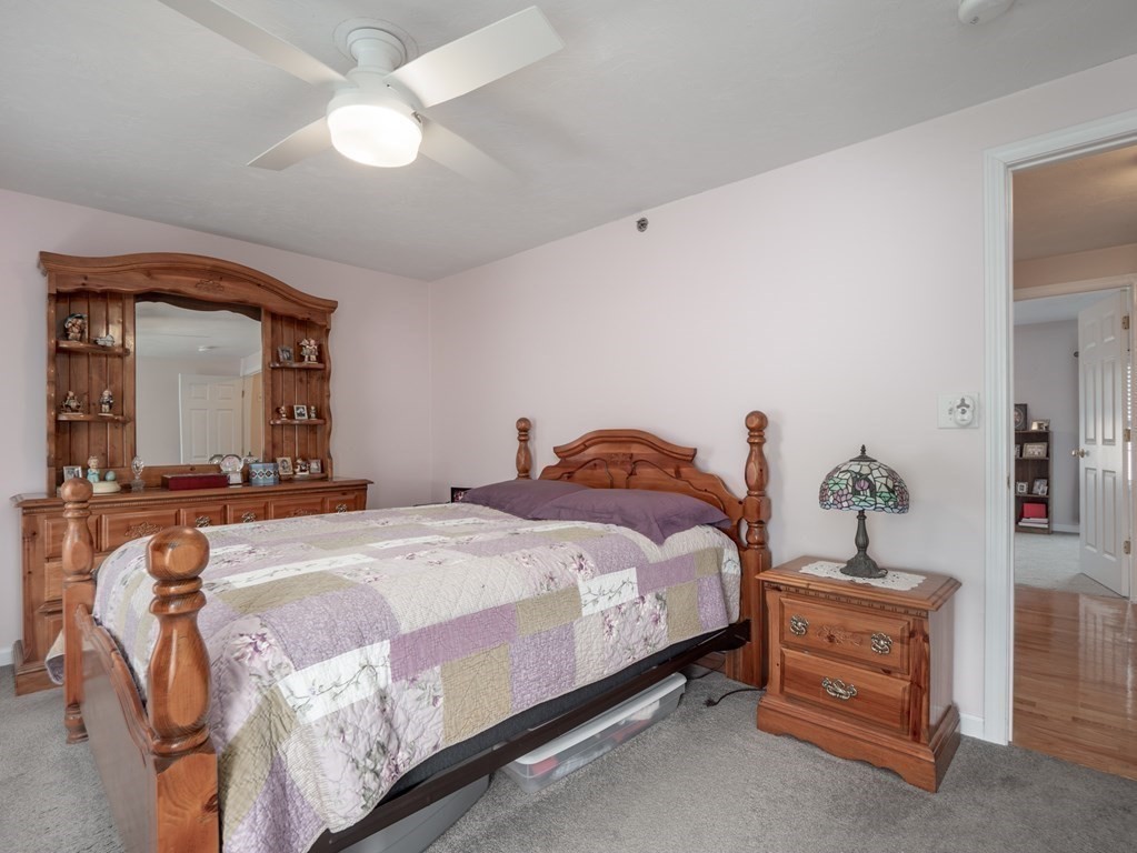 41 Boston Road, Unit 175 Billerica, MA 01862 - Photo 15 of 26 a bedroom with a bed and a chandelier