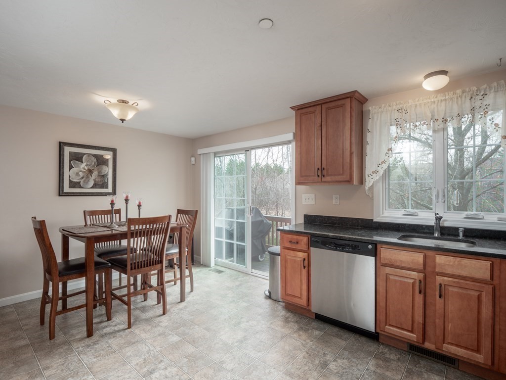 41 Boston Road, Unit 175 Billerica, MA 01862 - Photo 5 of 26 a kitchen with granite countertop sink table and chairs