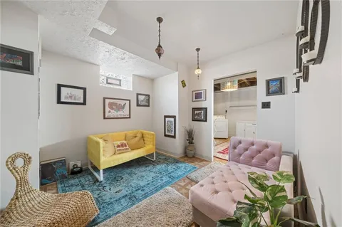 a bedroom with a bed couch and a window