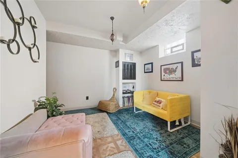 a living room with furniture and a chandelier