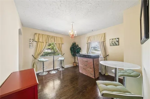 a living room with furniture a window and wooden floor