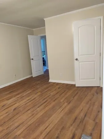 an empty room with wooden floor