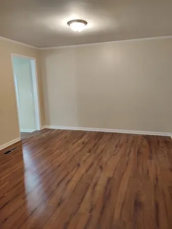 a view of room with wooden floor