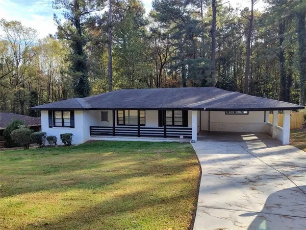 a view of a house with swimming pool next to a yard