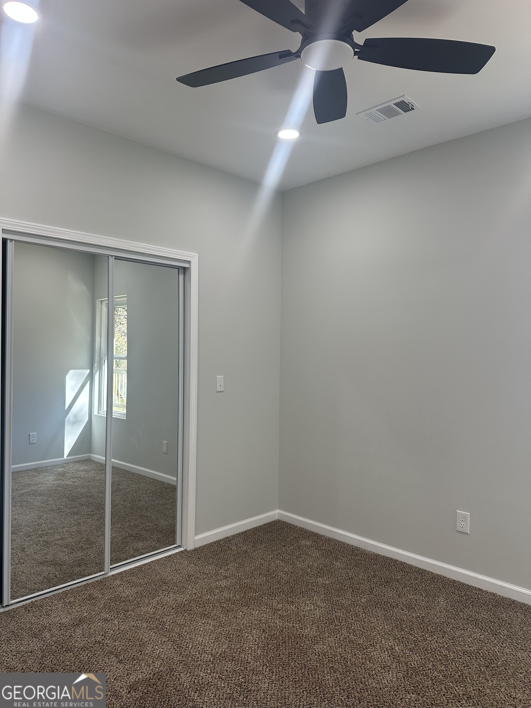 119 F Street Thomaston, GA 30286 - Photo 19 of 27 an empty room with sliding door and wooden floor