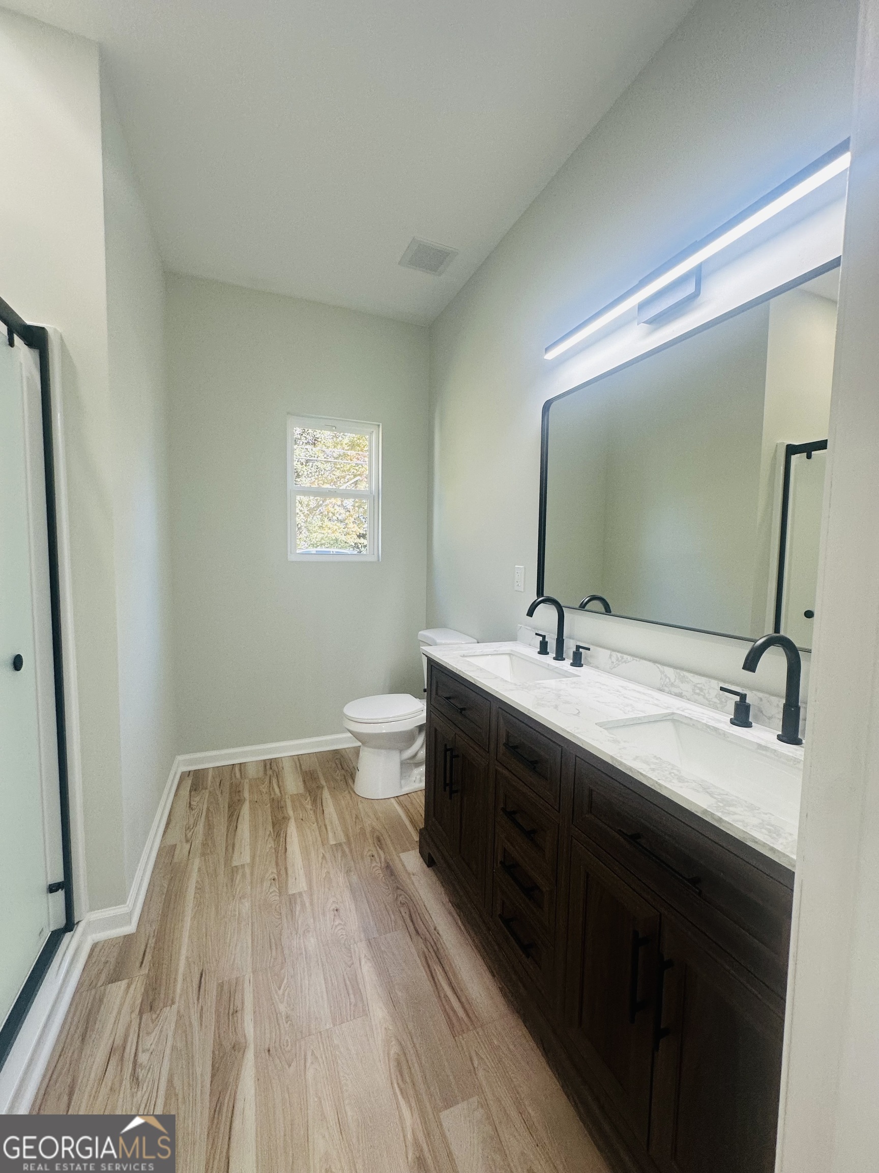 119 F Street Thomaston, GA 30286 - Photo 23 of 27 a bathroom with a double vanity sink and mirror