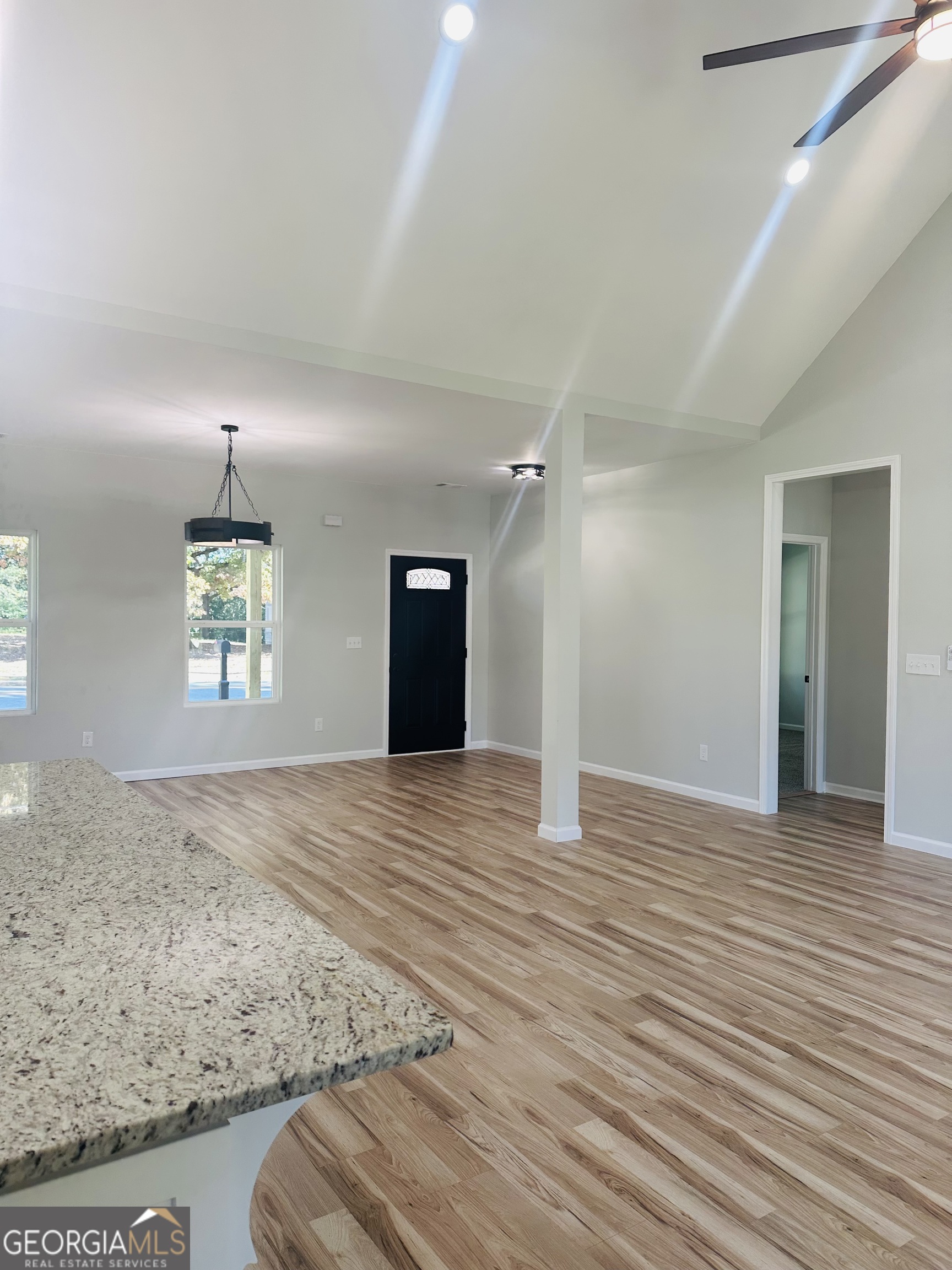 119 F Street Thomaston, GA 30286 - Photo 6 of 27 an empty room with wooden floor and windows