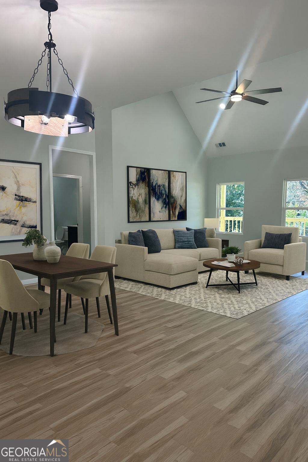 119 F Street Thomaston, GA 30286 - Photo 9 of 27 a living room with furniture and a chandelier