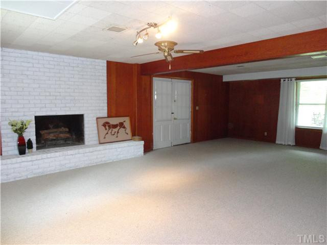 8804 Katharina Court Raleigh, NC 27613 - Photo 12 of 22 Spacious family room with fireplace and brand new carpet!