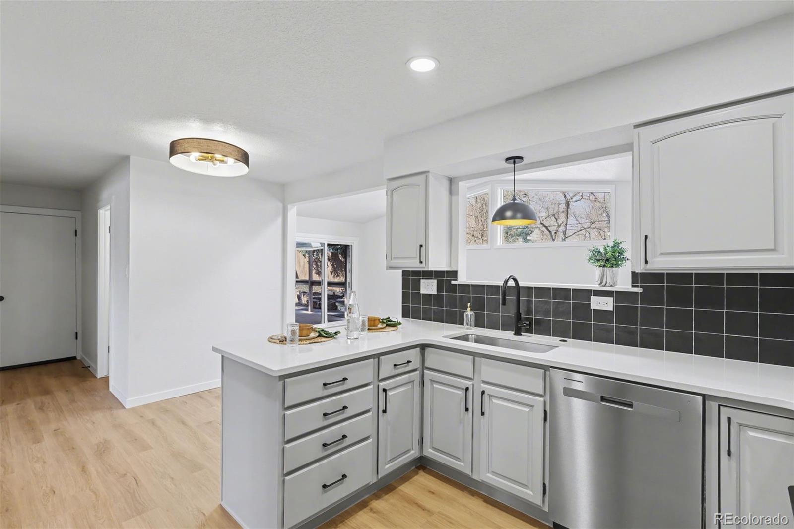 1002 Milky Way Colorado Springs, CO 80905 - Photo 12 of 39 a kitchen with a sink cabinets and window