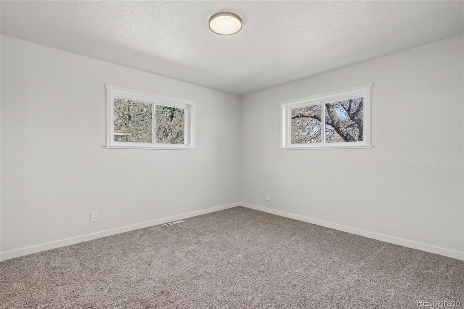 1002 Milky Way Colorado Springs, CO 80905 - Photo 14 of 39 an empty room with a painting on the wall
