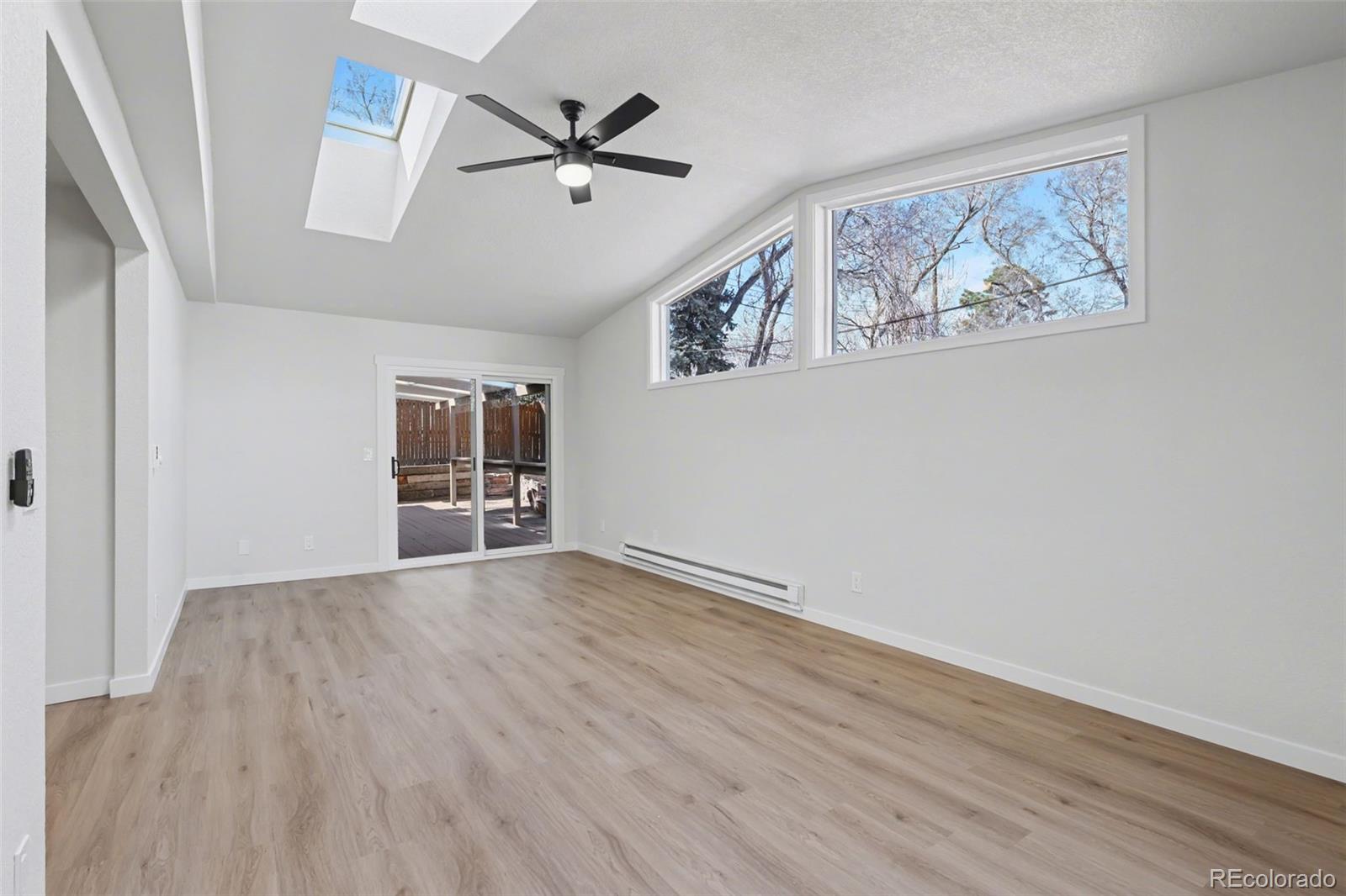1002 Milky Way Colorado Springs, CO 80905 - Photo 6 of 39 wooden floor in an empty room with a window