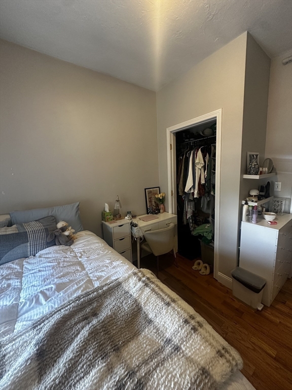199 Athens Street, Unit 3 Boston, MA 02127 - Photo 12 of 18 a bedroom with a bed and wooden floor